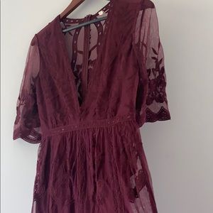 Burgundy short romper with long lace overlay.